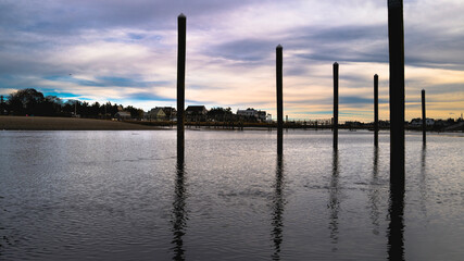 Abstract geometry and reflections of the pilings and poles under the bridge in the South River.