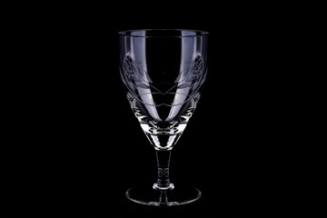 Empty wine glass on a black background, close up, isolated
