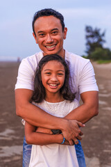 holidays, children and family concept -asian outdoor portrait of dad embrace his daughter outdoor