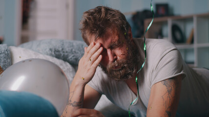 Guy waking up and suffering from hangover