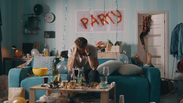 Guy with hangover sitting on sofa
