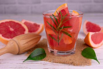 Grapefruit juice in a glass on a white background.