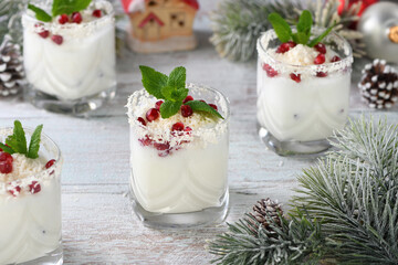 White Christmas mojito made from liqueur, tequila, coconut milk with pomegranate seeds, coconut...