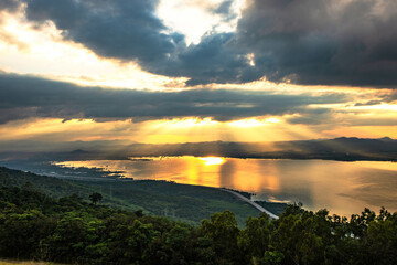 The evening sun shines through the clouds on Lam Ta Khong Reservoir, Nakhon Ratchasima Province, Thailand.