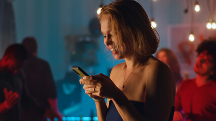 Woman sending voice message during party
