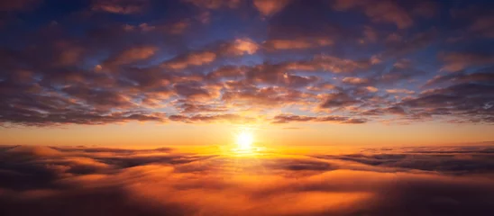 Fotobehang Wide panorama of setting sun from the plane. Beautiful dream-like photo of flying above the clouds © Vitalii