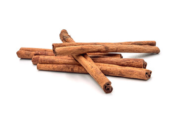 Herb, heap of dried cinnamon bark, isolated on a white background.