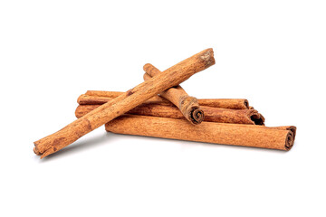 Herb, heap of dried cinnamon bark, isolated on a white background.