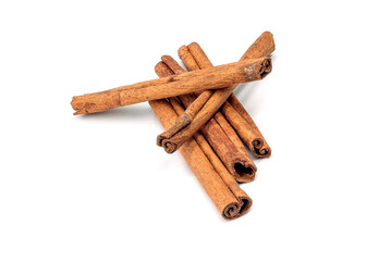 Herb, heap of dried cinnamon bark, isolated on a white background.