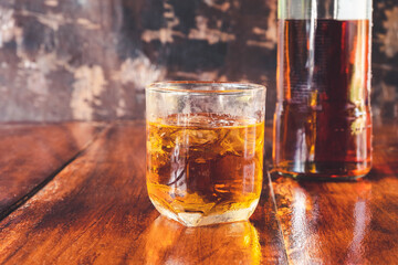  Liquor  glass and liquor bottles on wooden table