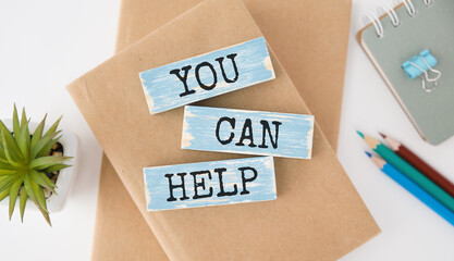You can help - phrase on wooden blocks with letters, mutual assistance companionship concept