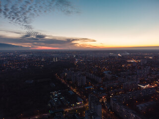 Aerial view Kharkiv city center, Pavlove pole with night lights on streets of residential district, scenic sunset view with epic skyscape