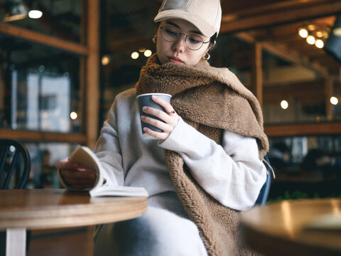 カフェで本を読む女性