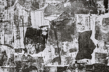 Abstract grunge black and white backdrop with scraps of paper and black paint spots. Torn paper...