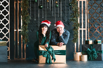 Male and female couple with present boxes, Christmas time photo