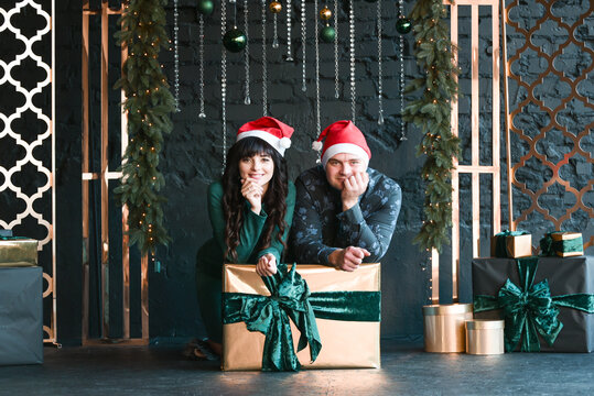 Male and female couple with present boxes, Christmas time photo