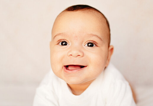 Close up portrait of happy and sweet little boy smiling.