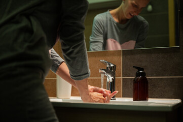 Young woman washing her hands