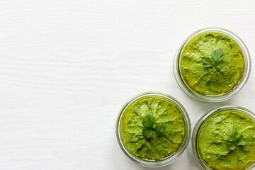 Fresh homemade parsley and sunflower seeds green pesto style dip. Top view with copy space.