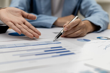 The sales department is having a monthly summary meeting to bring it to the department manager, they are verifying the correctness of the documents that are prepared before bringing in to the manager