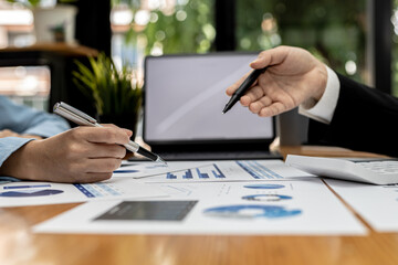 Fototapeta premium Meeting room atmosphere, business people meeting together on finance topics, they are working together to plan and solve corporate finance issues. Concept of business administration and finance.