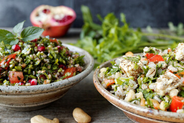 Traditional Tabbouleh salad with parsley and other tabbouleh style salad with barley and feta. Middle Eastern cuisine.