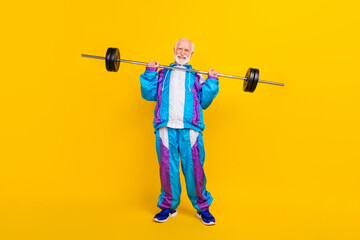 Full length photo of retired grandfather retro costume intense trainee barbell isolated over yellow...