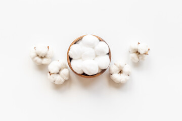 Cotton baby balls with cotton flowers, top view