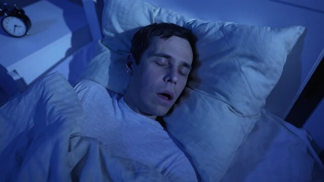 Man snoring while deep sleep in bed