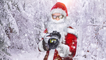 cool Santa Claus taking holiday pictures in the snowy landscape