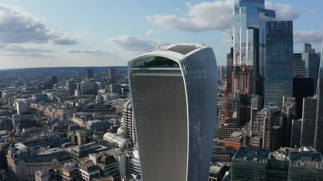 Slide and pan footage of new modern skyscraper with futuristic design. Tall office buildings in City financial and economic hub. London, UK