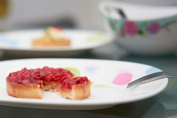 classic red berry curd tart on glod plate on table with copy space