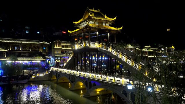 Bridge pavilion at Fenghuang Ancient Town by night. Xiangxi, Hunan, China.