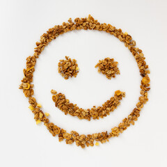 smiling face of cereal flakes on white background