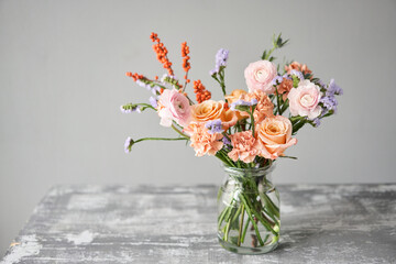 Finished flower arrangement in a vase for home. Flowers bunch, set for interior. Fresh cut flowers for decoration home. European floral shop. Delivery fresh cut flower.