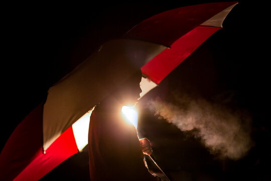 Silhouette Profile of girl under umbrella