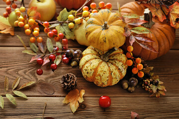 autumn background with pumpkins and colorful leaves on wooden background. Halloween or Thanksgiving Day design