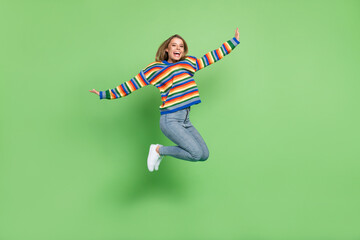 Full length body size profile photo girl jumping high laughing happy isolated pastel green color background