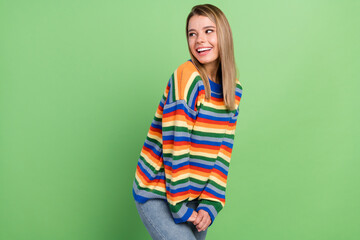 Photo portrait girl laughing looking copyspace in striped sweater isolated pastel green color background