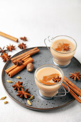 Masala tea in a glass cup with cardamom, star anise and cinnamon. Antiviral drink for immunity.