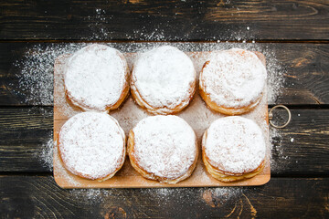 Cooking Hanukkah donuts or sufganiyot. Traditional sweets for Jewish holiday. Fresh berliner dessert at home kitchen.