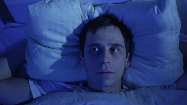 A man tries to sleep while neighbors are having a party
