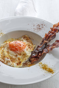 Delicious breakfast of fried eggs and bacon slices
