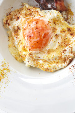 Delicious breakfast of fried eggs and bacon slices
