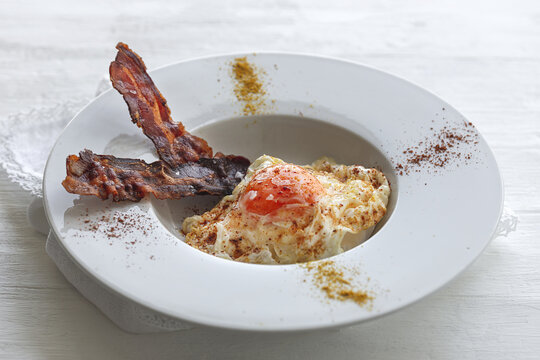 Delicious breakfast of fried eggs and bacon slices