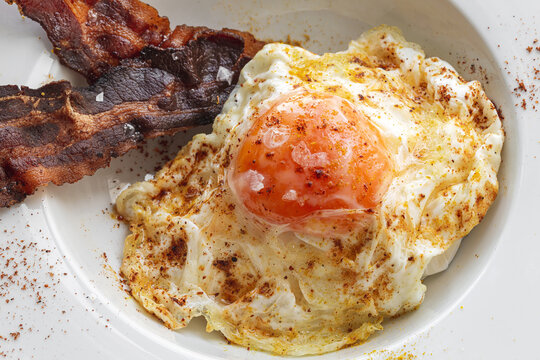 Delicious breakfast of fried eggs and bacon slices
