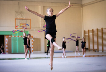 Girl gymnast who is going to jump in gym on training