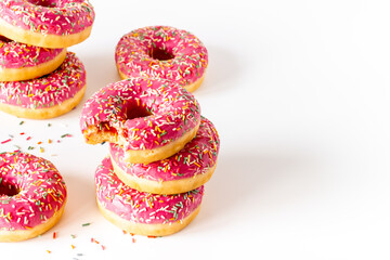 Sweet snacks - pink frosted donuts with colorful sprinkles