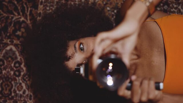 Woman With Afro Hair Focussing Vintage 8Mm Camera