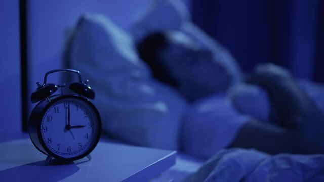 Clock and sleeping man on the background